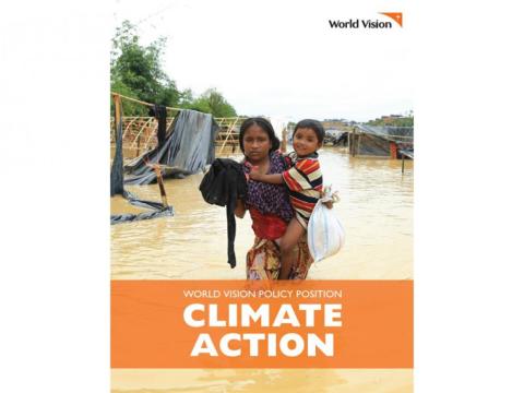 Climate action research cover shows a woman holding her child as she wades through water